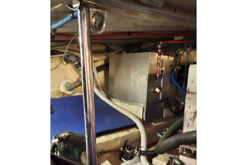 Slide: The Image of Engine room of 1984 Albin Palm Beach 37 with visible pipes and equipment. - 64