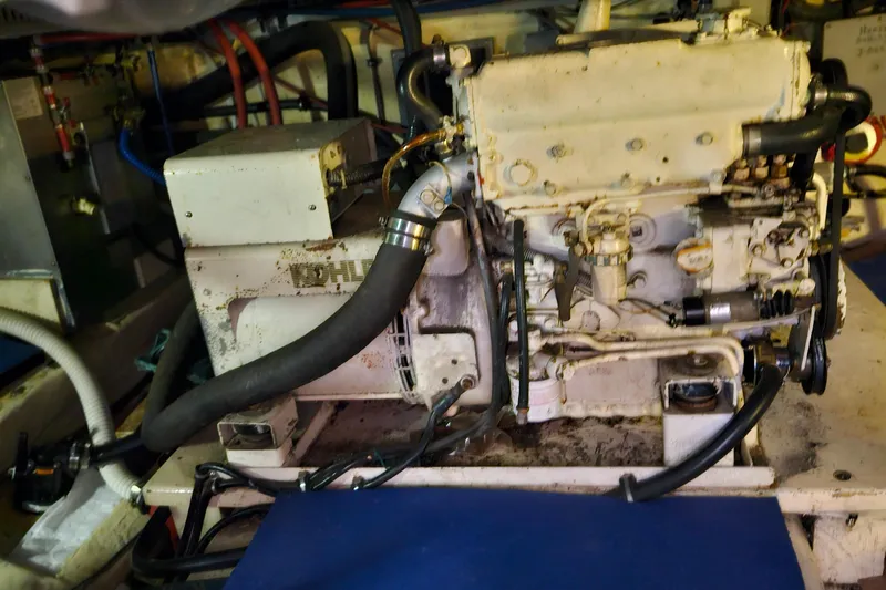 Slide: The Image of Engine room of 1984 Albin Palm Beach 37 boat, featuring mechanical components and hoses. - 69