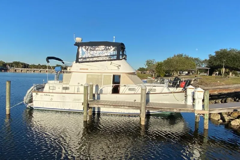 Slide: The Image of 1984 Albin Palm Beach 37 yacht docked on a sunny day. - 2