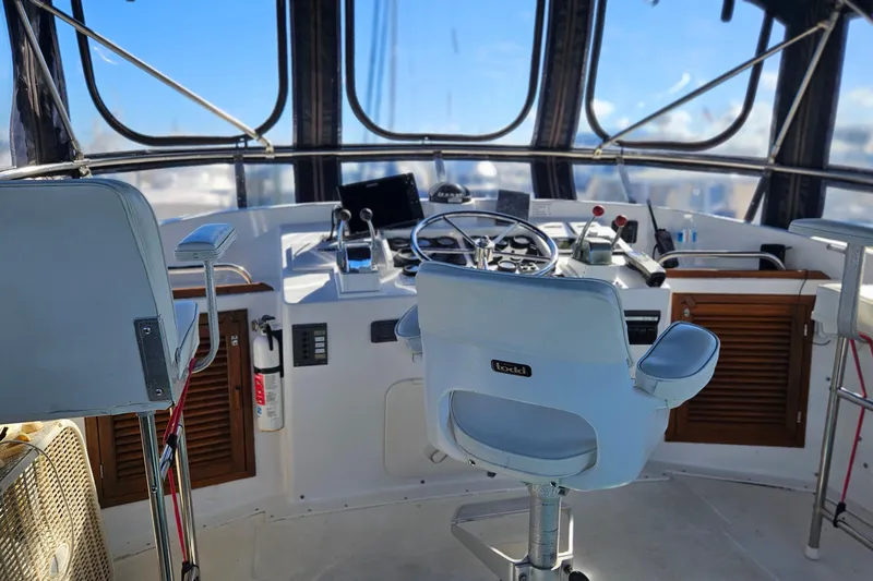 Slide: The Image of Helm of 1984 Albin Palm Beach 37 yacht with steering wheel and controls. - 23