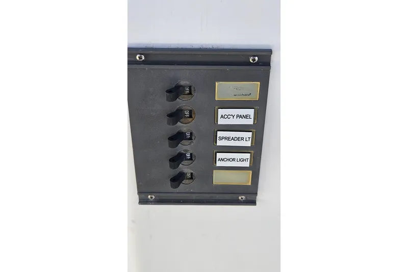 Slide: The Image of Control panel on 1984 Albin Palm Beach 37 boat with labeled switches. - 24