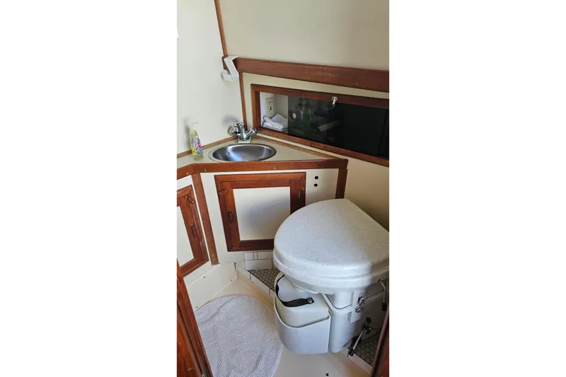 Slide: The Image of Compact bathroom in 1984 Albin Palm Beach 37 yacht with sink and toilet. - 27