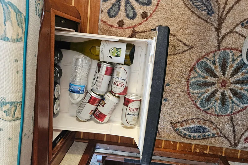 Slide: The Image of Mini fridge on 1984 Albin Palm Beach 37 with drinks and floral carpet. - 38