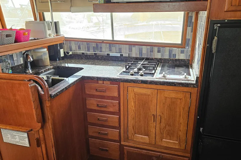 Slide: The Image of 1984 Albin Palm Beach 37 yacht kitchen with wooden cabinets and modern appliances. - 39