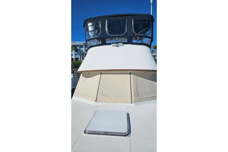 Slide: The Image of 1984 Albin Palm Beach 37 yacht with covered deck and clear blue sky. - 4