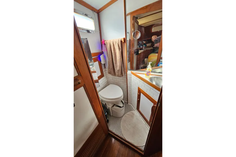 Slide: The Image of 1984 Albin Palm Beach 37 yacht bathroom with wooden accents and compact design. - 56