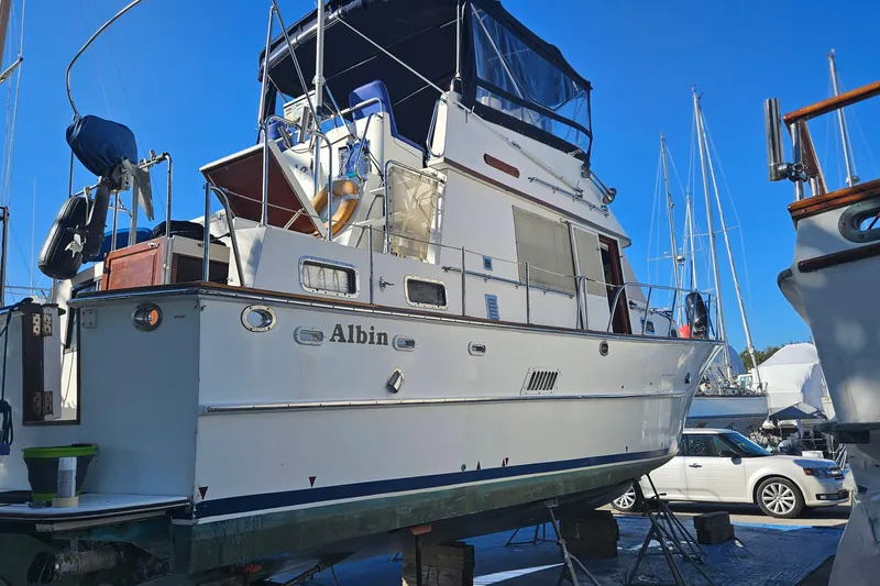 Slide: The Image of 1984 Albin Palm Beach 37 yacht on dry dock, showcasing its classic design and structure. - 6