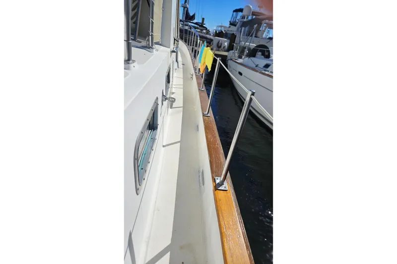 Slide: The Image of 1984 Albin Palm Beach 37 yacht deck with railing and docked boats. - 9