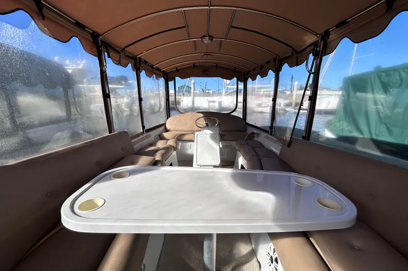 Slide: The Image of Interior of a 2005 Duffy Classic 21 boat with seating and table. - 6