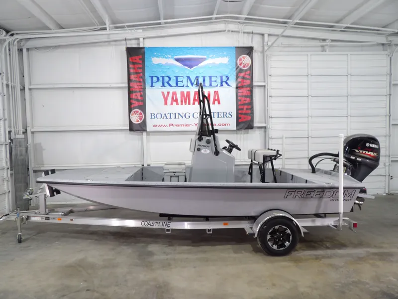 Slide: The Image of 2024 Freedom 18 Patriot Cat boat in showroom. - 1