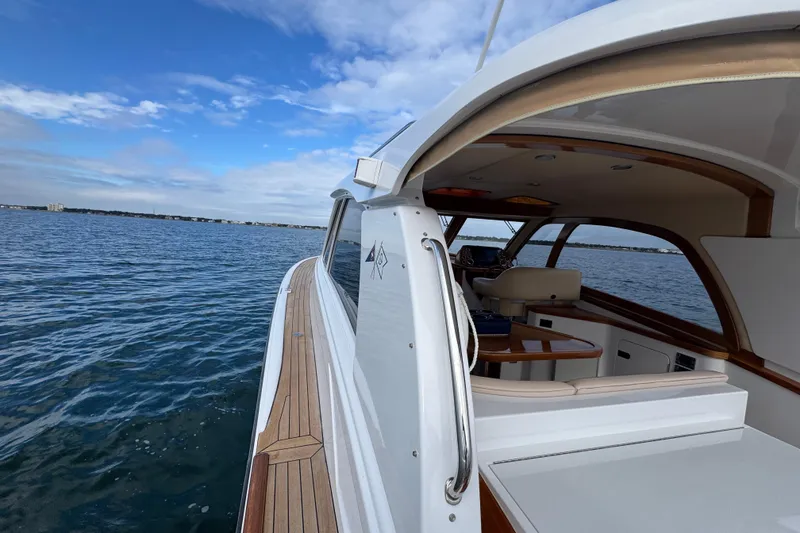 Slide: The Image of 2014 San Juan 41 yacht cruising on open water under a clear blue sky. - 21
