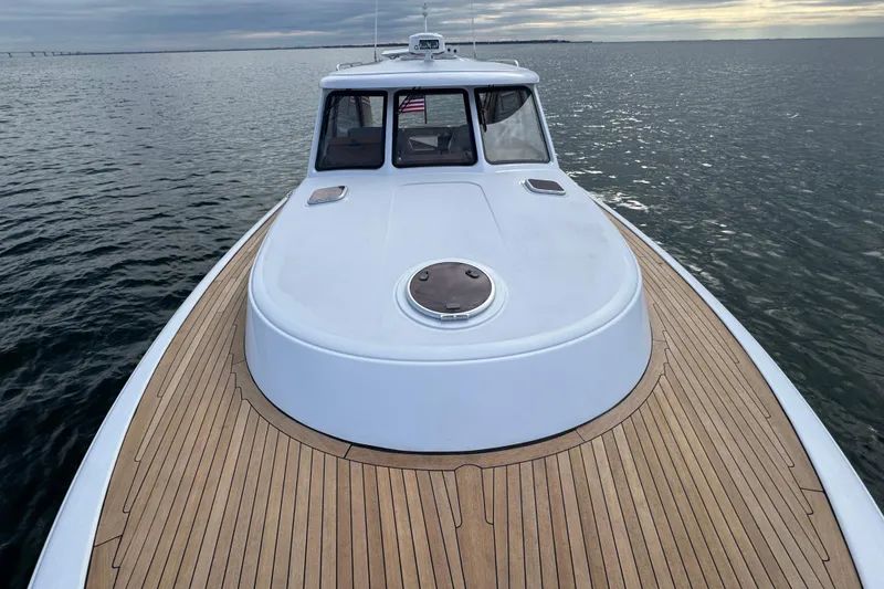 Slide: The Image of San Juan 41 yacht, 2014 model, with teak deck cruising on calm waters. - 25