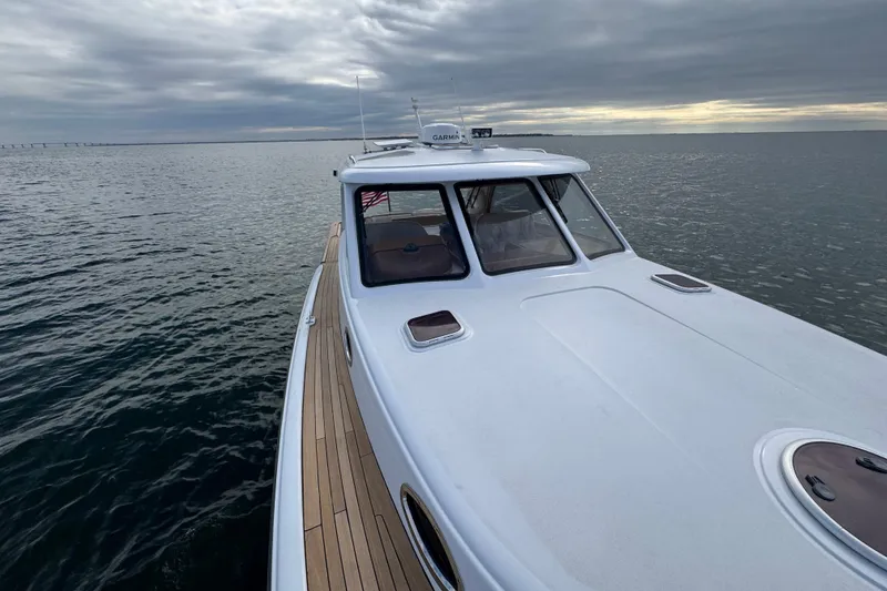 Slide: The Image of San Juan 41 yacht cruising on calm waters under a cloudy sky, 2014 model. - 27