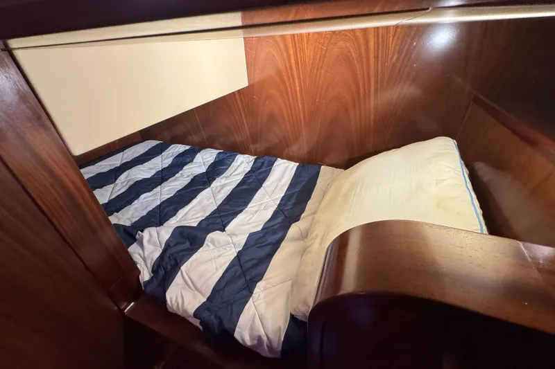 Slide: The Image of Cozy cabin bed with striped bedding in 2014 San Juan 41 yacht. - 30