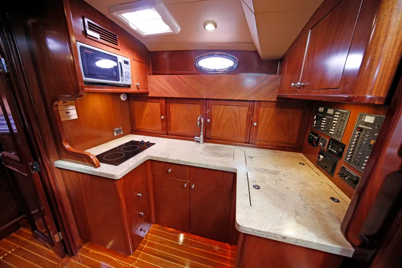Slide: The Image of Luxurious wooden interior of 2014 San Juan 41 yacht kitchen with modern amenities. - 34