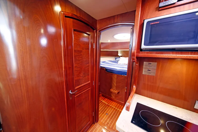 Slide: The Image of Luxurious 2014 San Juan 41 yacht interior with wood finish, kitchenette, and cozy sleeping area. - 35