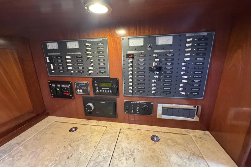 Slide: The Image of Electrical control panel on a 2014 San Juan 41 yacht, featuring switches and meters. - 37