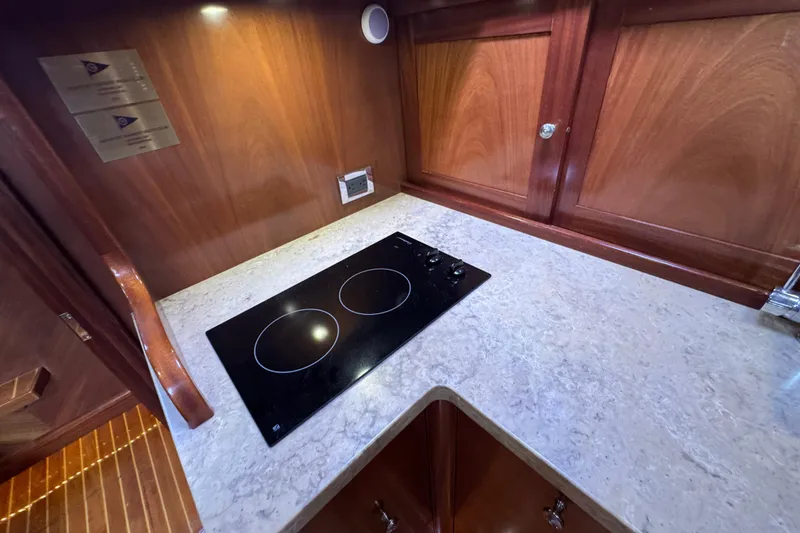 Slide: The Image of Luxury yacht kitchen with sleek cooktop, wooden cabinetry, and elegant countertop, San Juan 41, 2014. - 39