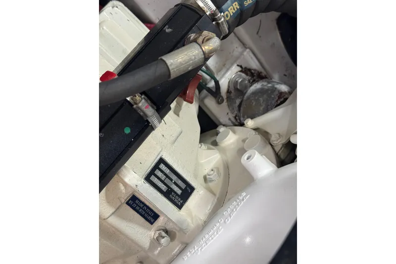 Slide: The Image of Close-up of a 2014 San Juan 41 engine component with visible labels and hoses. - 44