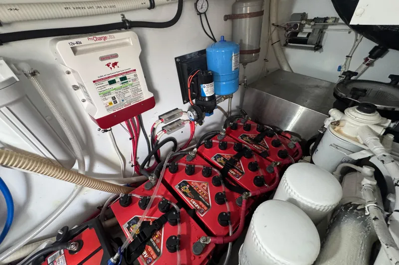 Slide: The Image of Engine room of 2014 San Juan 41 with batteries and charging system. - 47