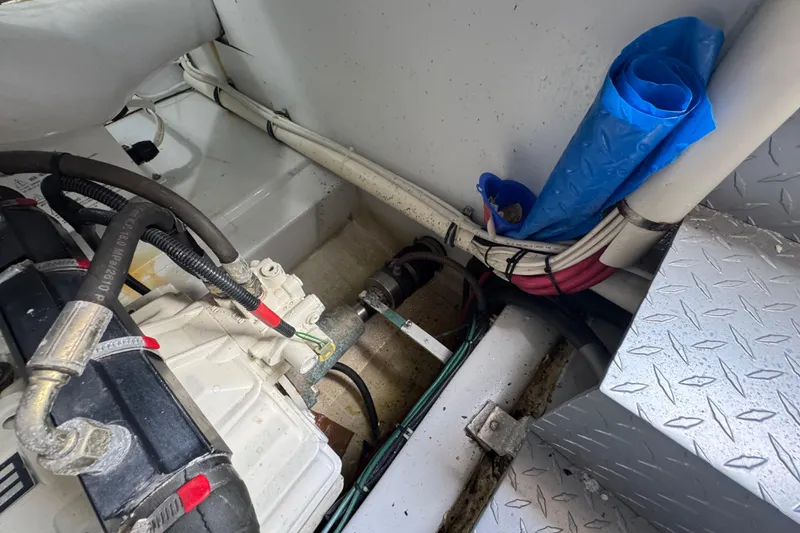 Slide: The Image of Engine compartment of 2014 San Juan 41 boat with cables and blue tarp. - 48
