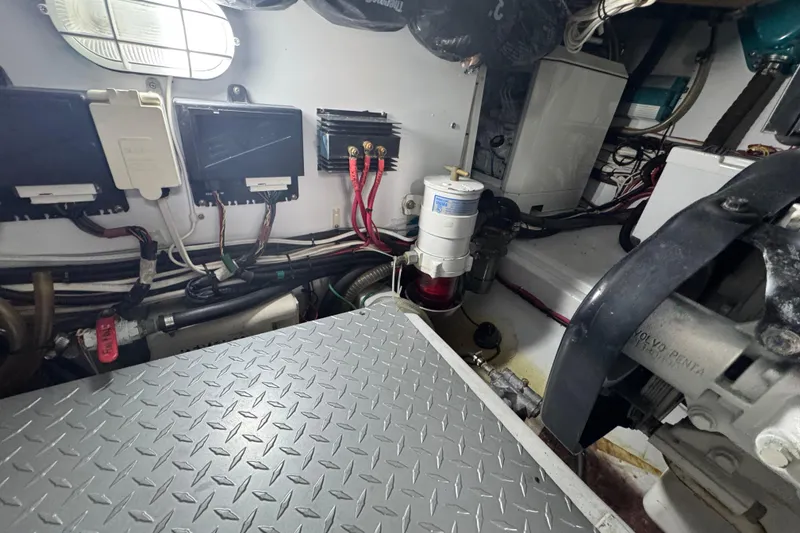 Slide: The Image of Engine room of a 2014 San Juan 41 boat, featuring wiring and mechanical components. - 49