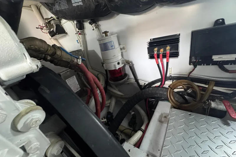 Slide: The Image of Engine room of a 2014 San Juan 41 boat, featuring cables and mechanical components. - 50