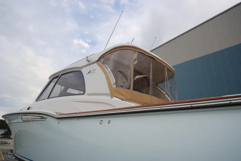 Slide: The Image of 2014 San Juan 41 yacht with enclosed cockpit, docked near a blue building. - 7