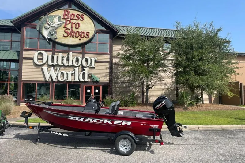 Slide: The Image of 2026 Tracker Super Guide V-16 SC boat outside Bass Pro Shops Outdoor World. - 2