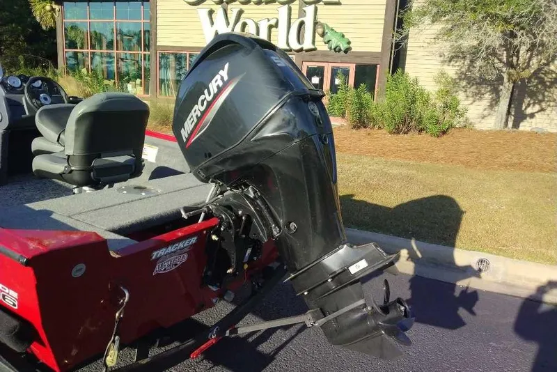 Slide: The Image of 2026 Tracker Super Guide V-16 SC boat with Mercury outboard motor, parked outdoors. - 5
