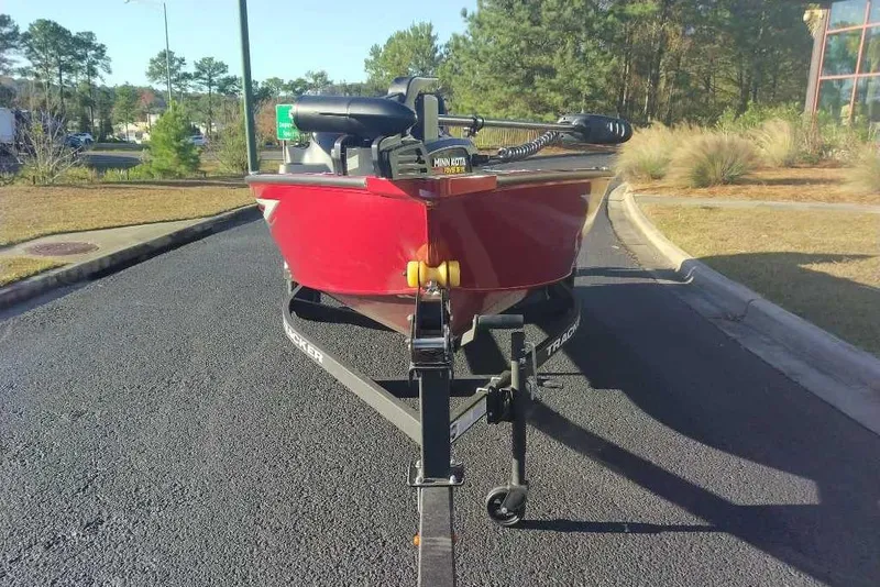 Slide: The Image of 2026 Tracker Super Guide V-16 SC boat on trailer, parked on asphalt road. - 8