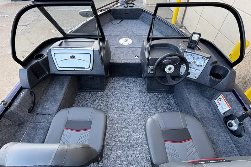 Slide: The Image of 2026 Tracker Pro Guide V-16 WT boat interior with steering wheel and seating. - 48