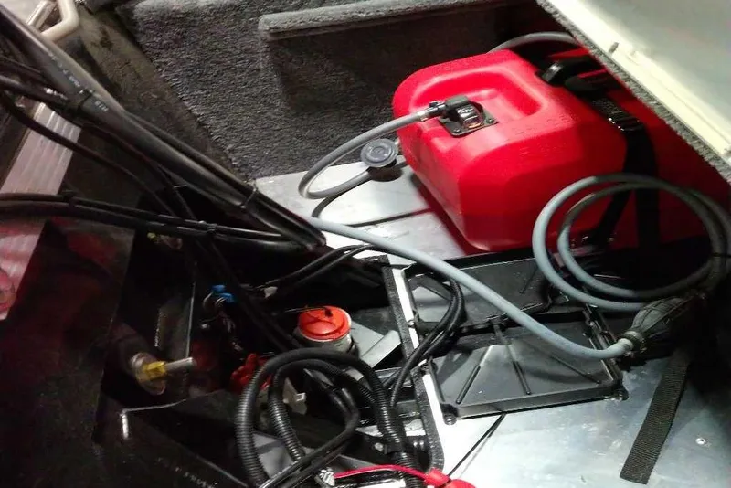 Slide: The Image of Interior view of 2026 Tracker Bass Tracker Classic XL boat with red fuel tank and cables. - 70