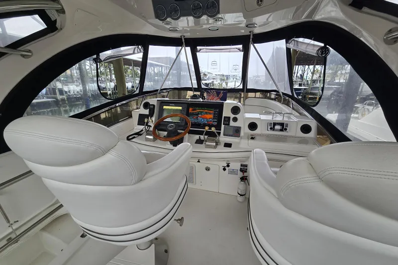 Slide: The Image of 2007 Sea Ray 52 Sedan Bridge interior with white seating and panoramic windows. - 12