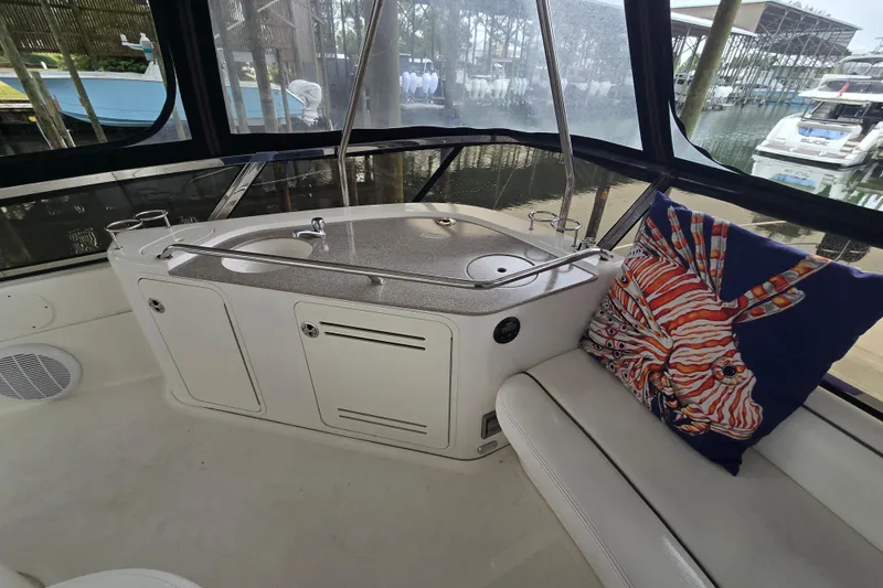 Slide: The Image of 2007 Sea Ray 52 Sedan Bridge interior with seating and sink, featuring panoramic windows. - 14