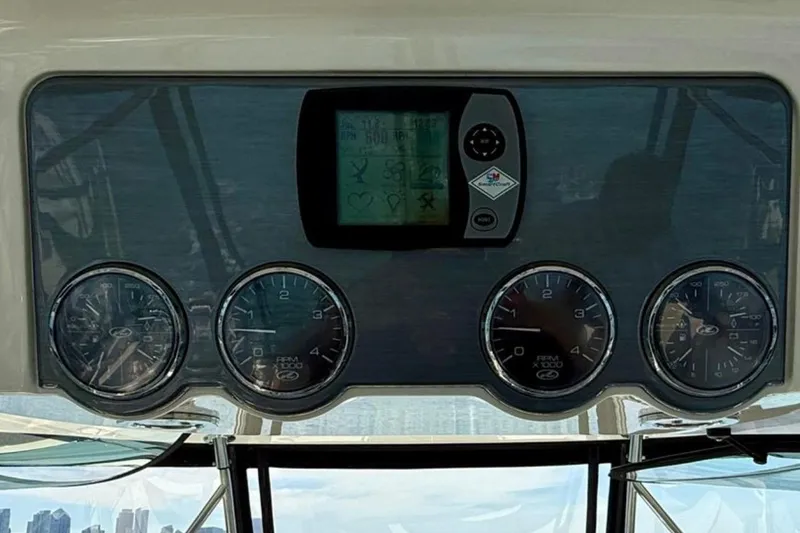Slide: The Image of 2007 Sea Ray 52 Sedan Bridge helm with navigation controls and display panel. - 23