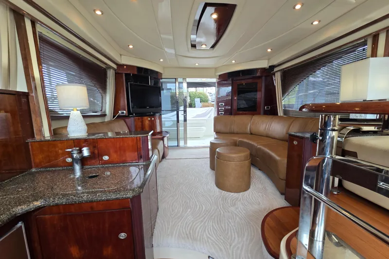 Slide: The Image of Luxurious interior of 2007 Sea Ray 52 Sedan Bridge yacht with leather seating and TV. - 31