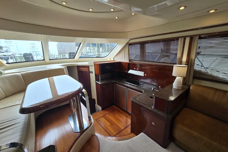 Slide: The Image of Luxurious interior of 2007 Sea Ray 52 Sedan Bridge yacht with elegant seating and wooden flooring. - 33