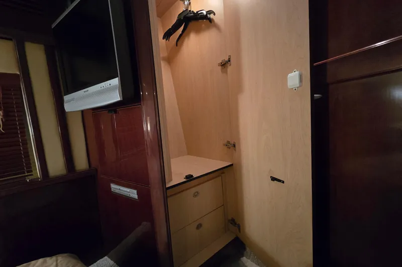 Slide: The Image of Luxurious cabin interior of 2007 Sea Ray 52 Sedan Bridge with TV and wooden blinds. - 44