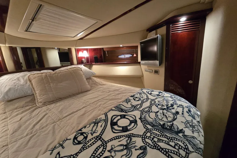 Slide: The Image of Luxurious bedroom interior of 2007 Sea Ray 52 Sedan Bridge yacht with nautical-themed bedding. - 50