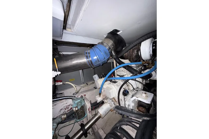 Slide: The Image of Engine room of 2007 Sea Ray 52 Sedan Bridge with visible pipes and components. - 58