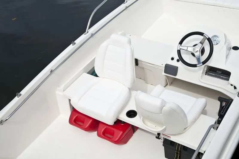 Slide: The Image of Manufacturer Provided Image: 2016 Boston Whaler 170 Super Sport boat interior with white seats and steering wheel. - 1