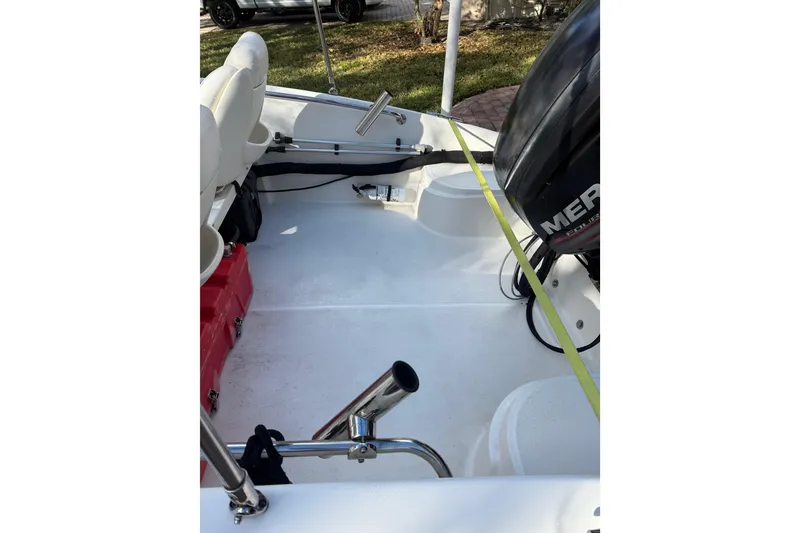 Slide: The Image of 2016 Boston Whaler 170 Super Sport interior with Mercury engine and seating. - 5