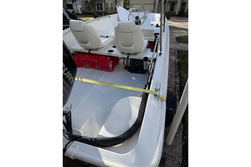 Slide: The Image of 2016 Boston Whaler 170 Super Sport boat interior with seats and steering wheel. - 8