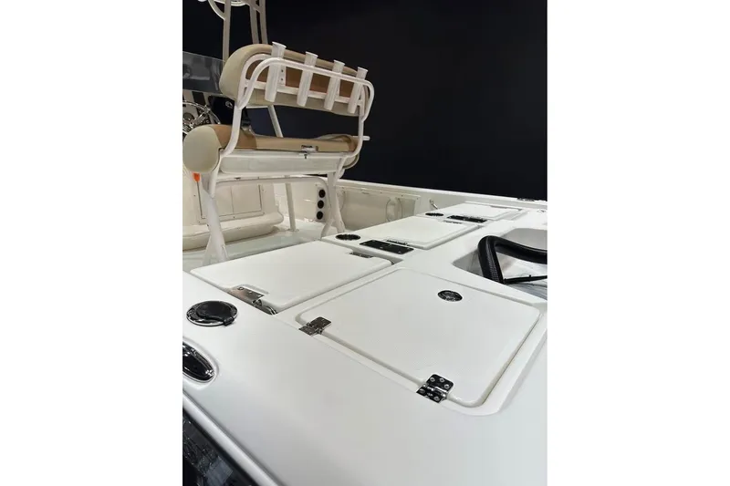 Slide: The Image of 2023 NauticStar 227 XTS boat interior with storage compartments and seating. - 11