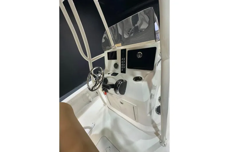 Slide: The Image of 2023 NauticStar 227 XTS boat console with steering wheel and controls. - 7