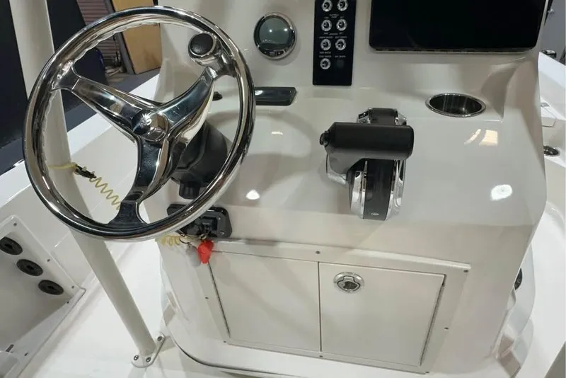 Slide: The Image of 2023 NauticStar 227 XTS boat console with steering wheel and controls. - 8
