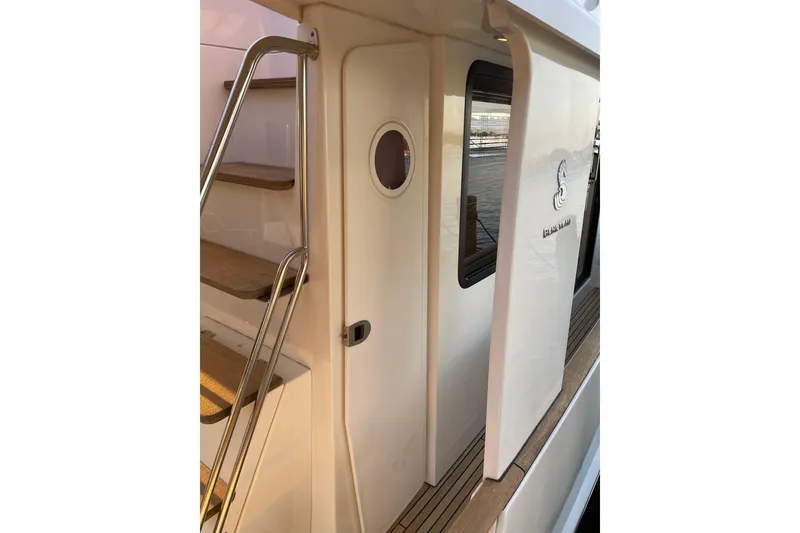 Slide: The Image of 2013 Beneteau Swift Trawler 44, exterior view with stairs and door. - 12