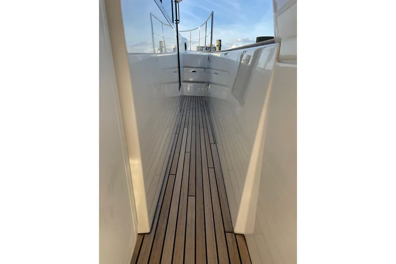 Slide: The Image of 2013 Beneteau Swift Trawler 44 deck with sleek wooden flooring and polished sides. - 13