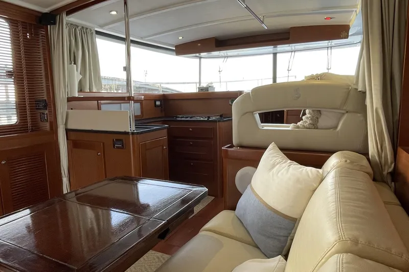 Slide: The Image of Interior of 2013 Beneteau Swift Trawler 44, featuring elegant wood finishes and comfortable seating. - 18